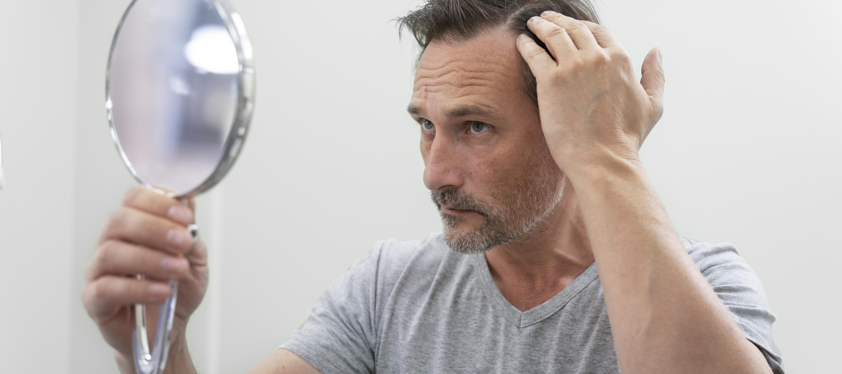 Man looking at his hair