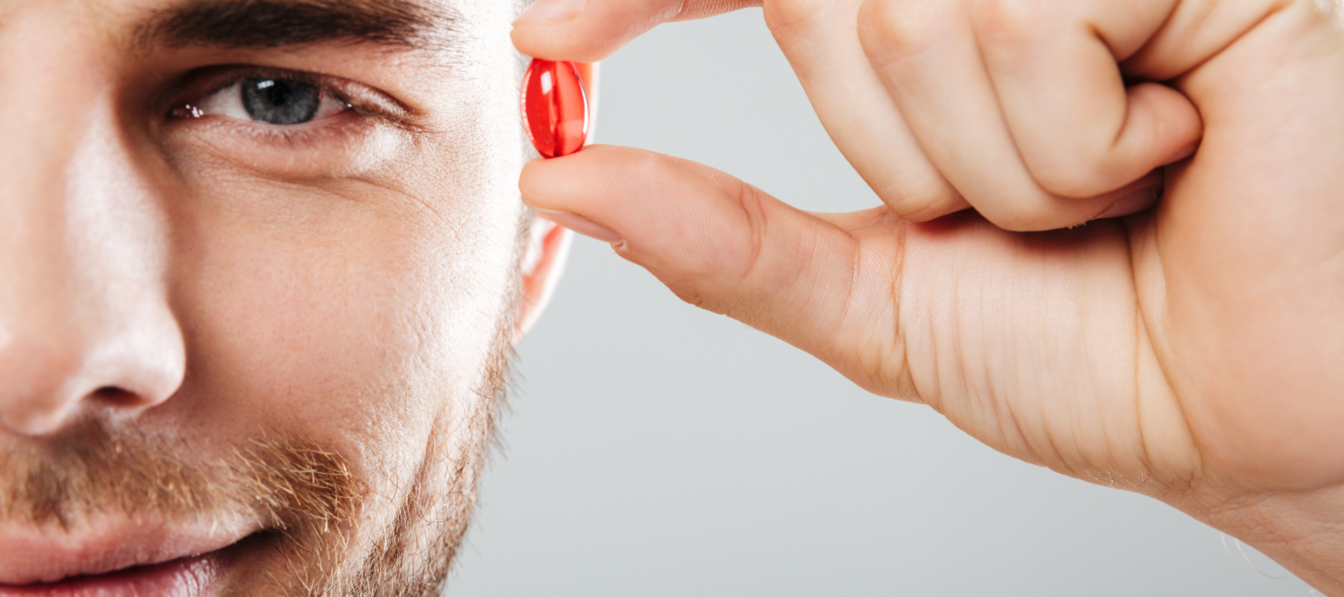 Man holding red pill