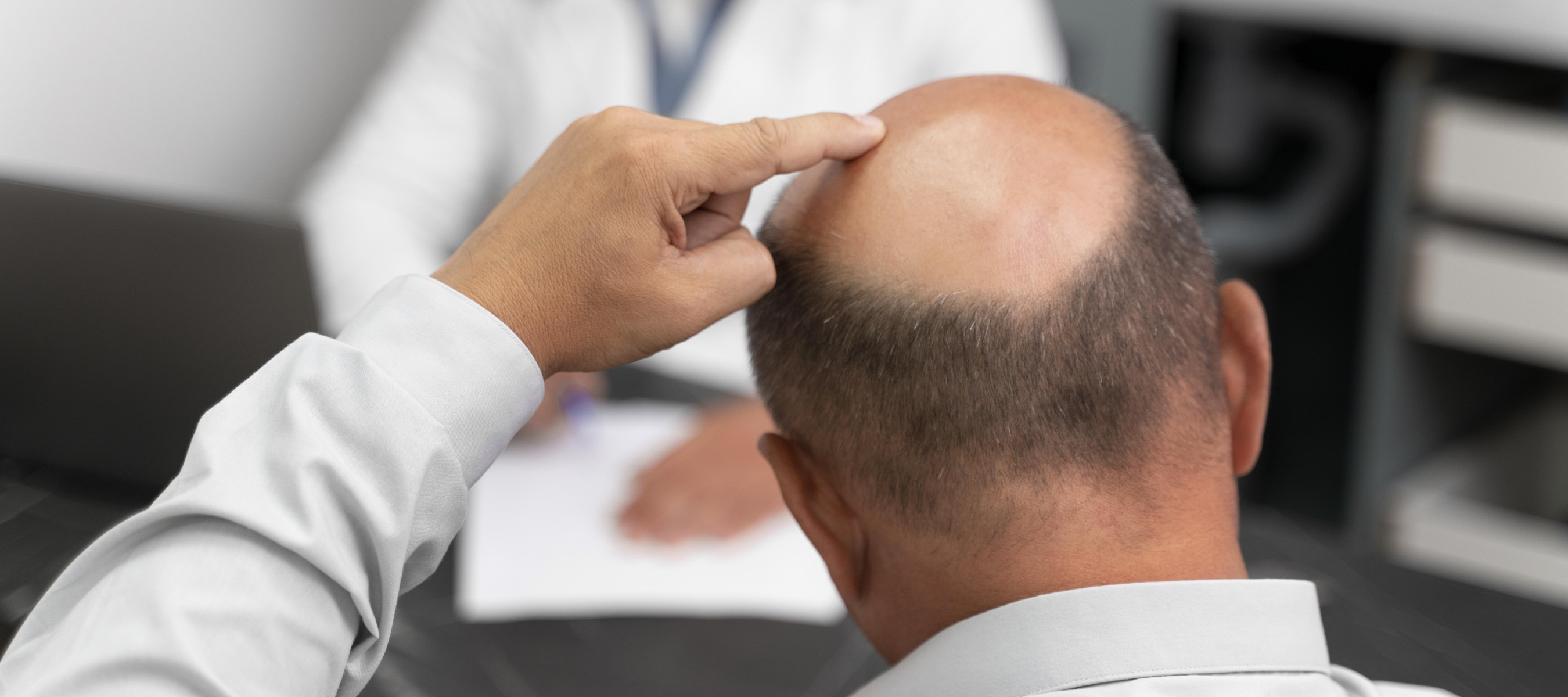 bald man consulting with specialist