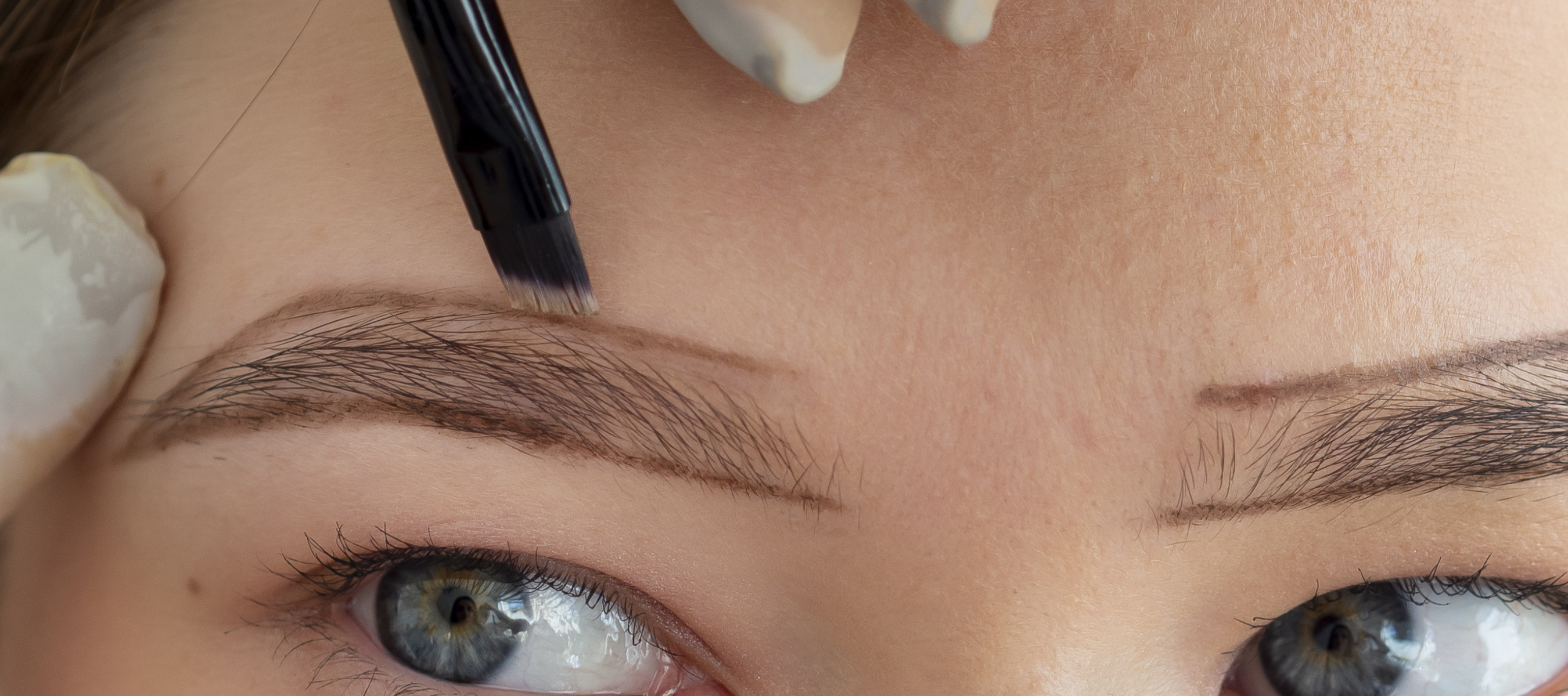 Doctor drawing eyebrow