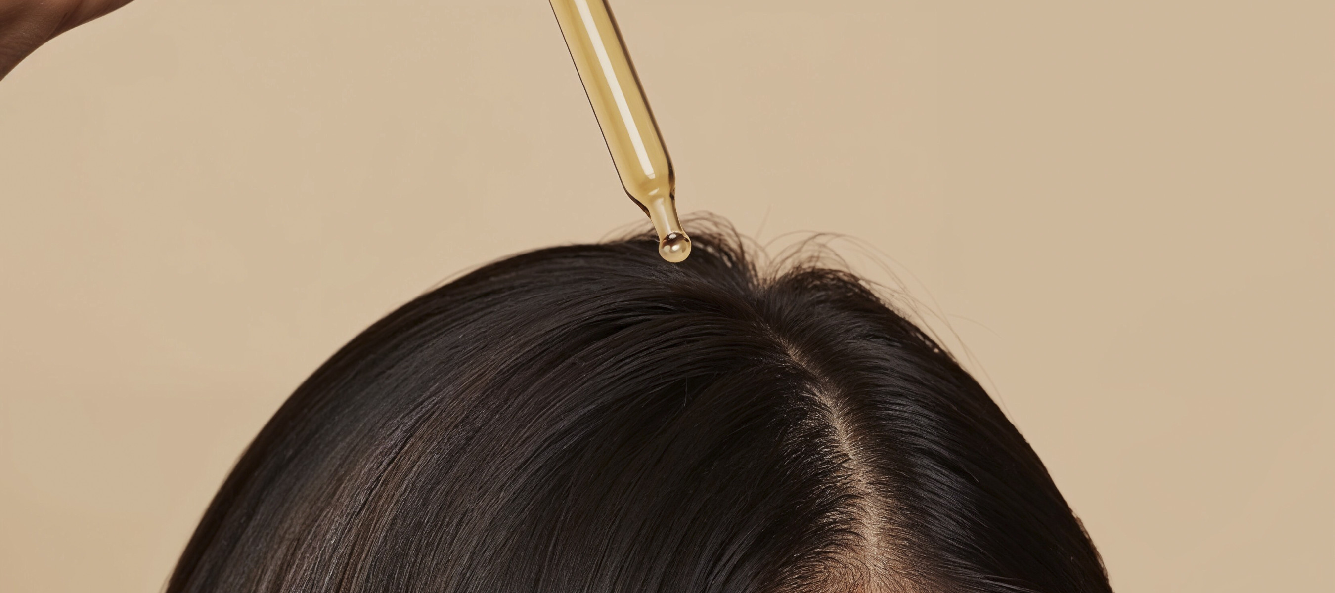 Woman applying hair serum