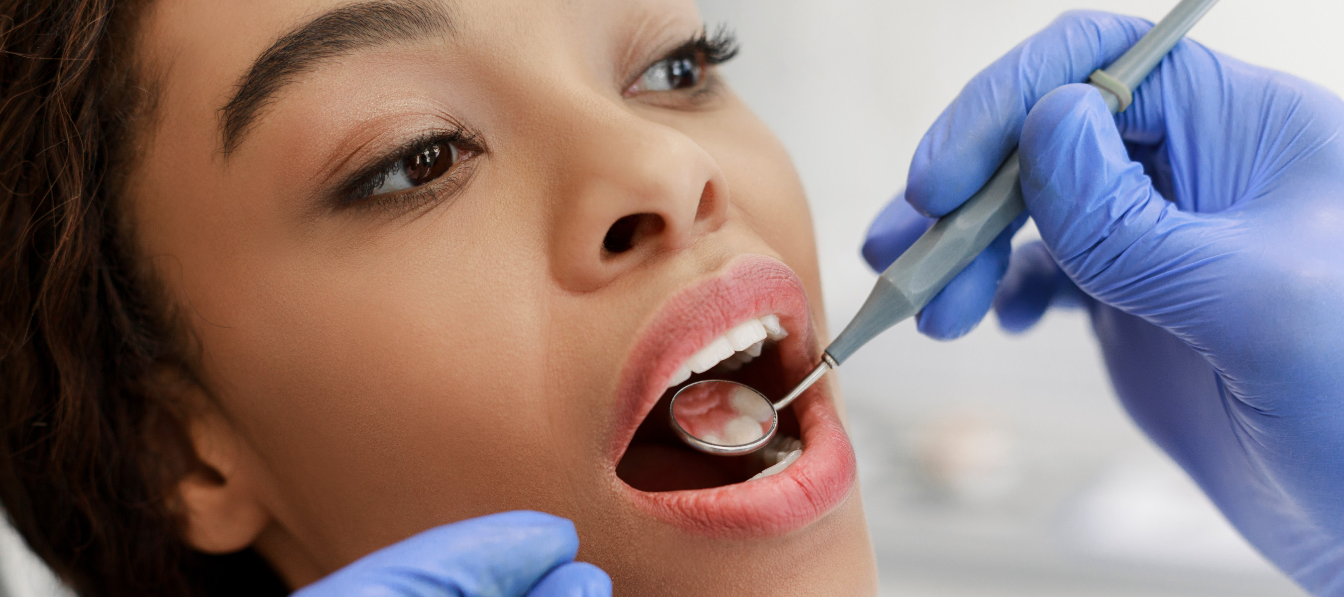 A women undergoing a dental check-up at her dentist.