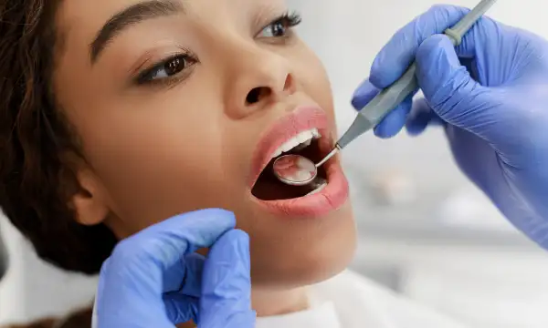 A women undergoing a dental check-up at her dentist.